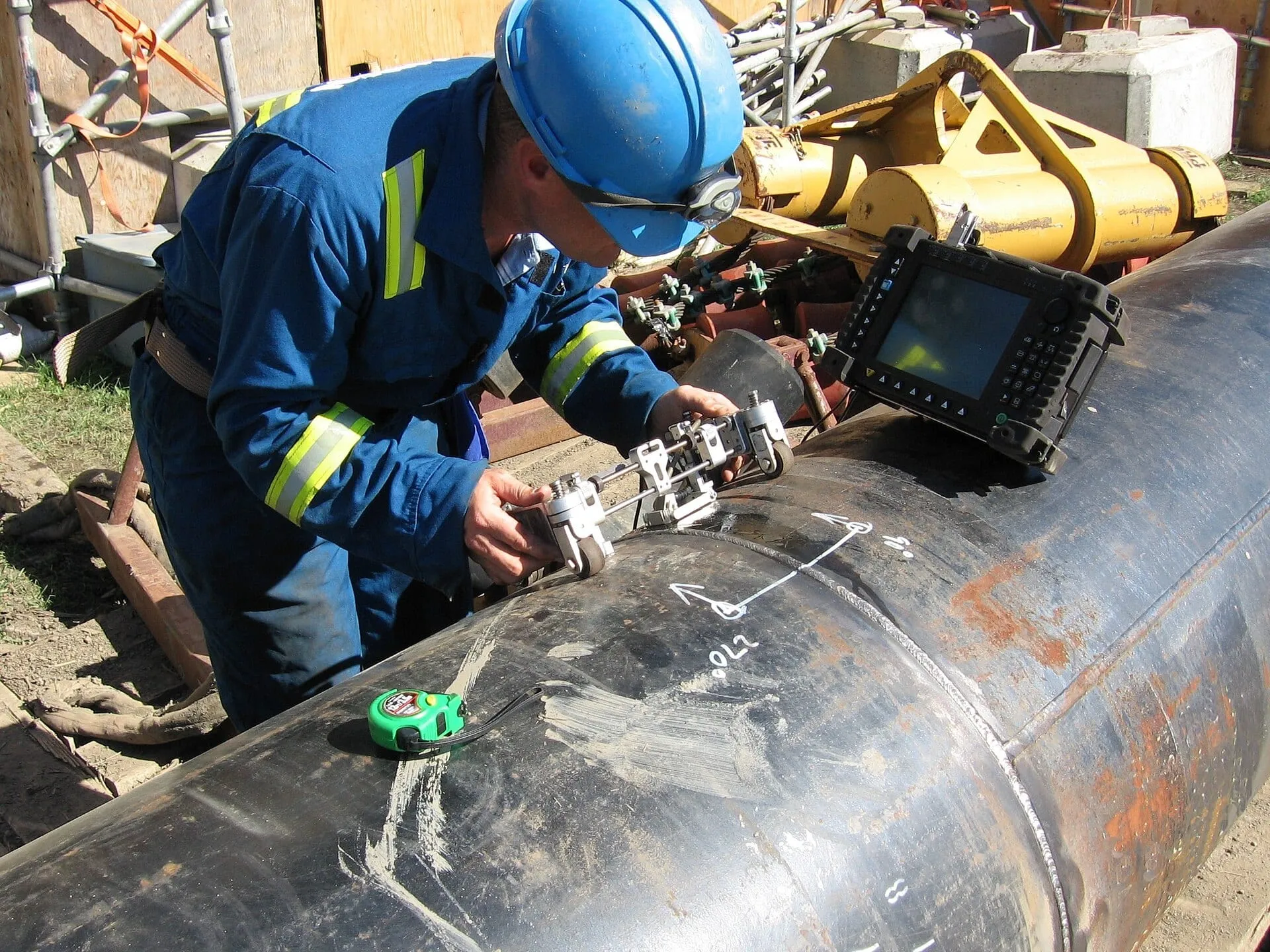 Surveyor scanning a weld with test equipment